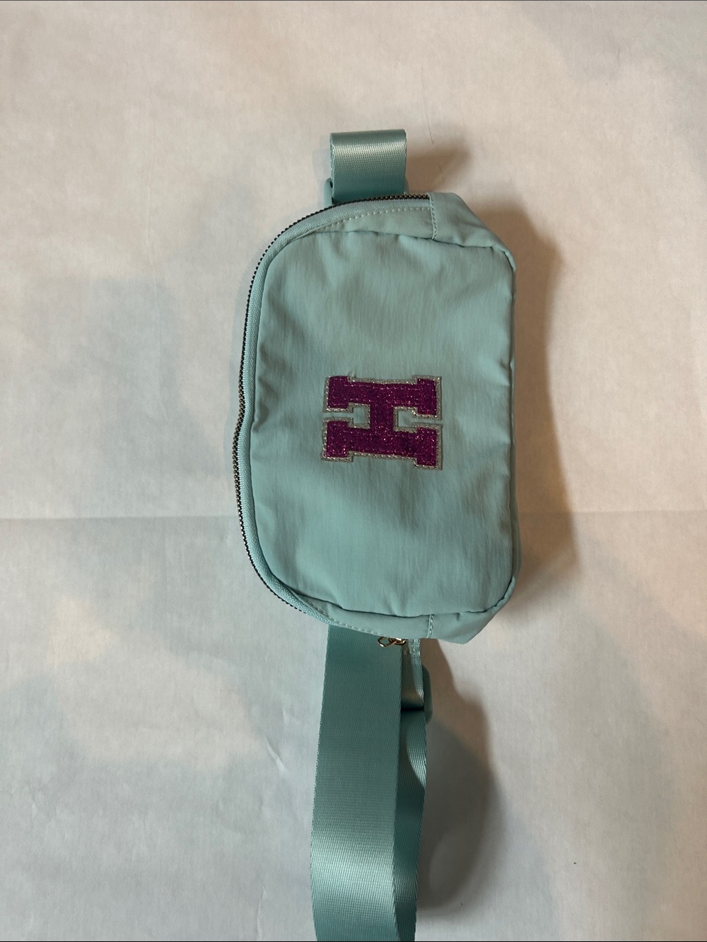 Light Teal Crossbody Belt Bag with Purple Accent